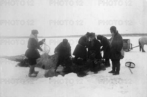 Ice fishing, 1890. Creator: Unknown.