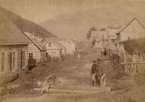 Main street in Petropavlovsk in Kamchatka. View of Mishennaya Sopka, 1890.  Creator: Unknown.