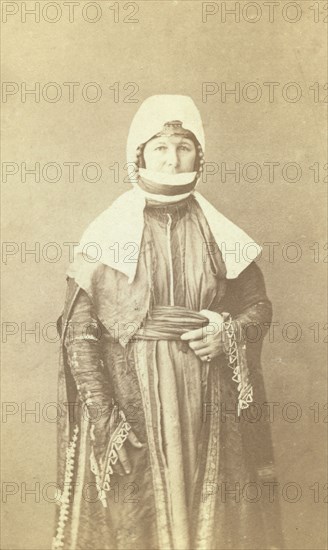 Three-quarter length portrait of woman, facing front, between 1870 and 1886. Creator: Unknown.