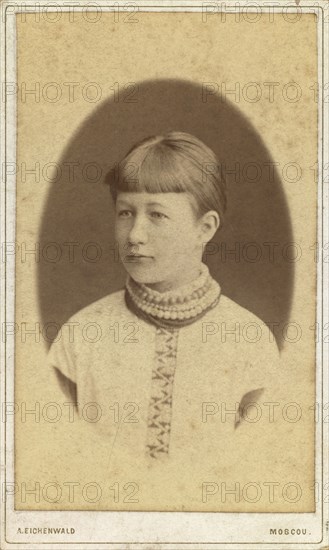 Head-and-shoulders portrait of a young woman, facing left, between 1880 and 1886. Creator: Unknown.