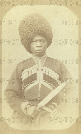 Three-quarter length portrait of man, seated, facing front, between 1870 and 1886. Creator: George Kennan.