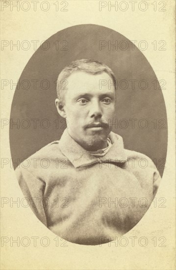 Head-and-shoulders portrait of a man, dressed in convict clothing, facing..., between 1880 and 1886. Creator: Unknown.