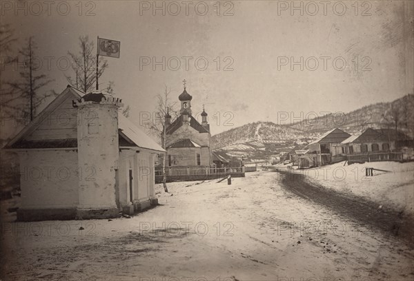 View of a settlement or village with a government(?) building and a church..., between 1885 and 86. Creator: Unknown.