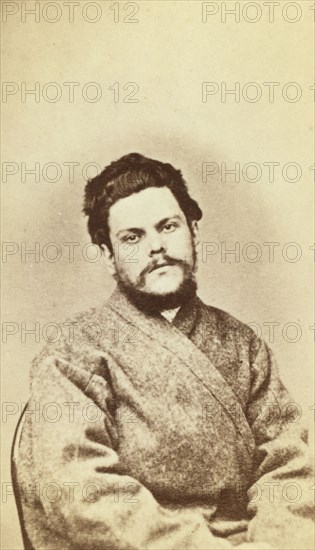 Half-length portrait of a man, dressed in convict clothing, facing front, between 1880 and 1886. Creator: Unknown.