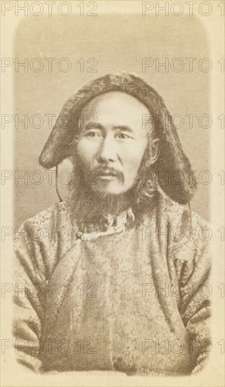 Half-length portrait of man, seated, facing slightly left, between 1870 and 1886. Creator: Unknown.