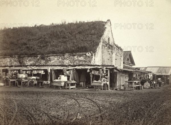 Market stalls beside old powder magazine, Irkutsk, between 1885 and 1886. Creator: Unknown.