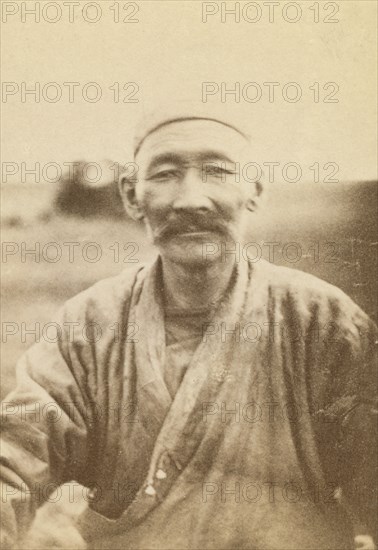 Half-length portrait of man, seated facing front, between 1870 and 1886. Creator: Unknown.