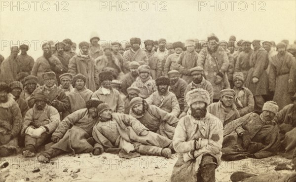 Group portrait of large group of convicts, between 1880 and 1886. Creator: Unknown.