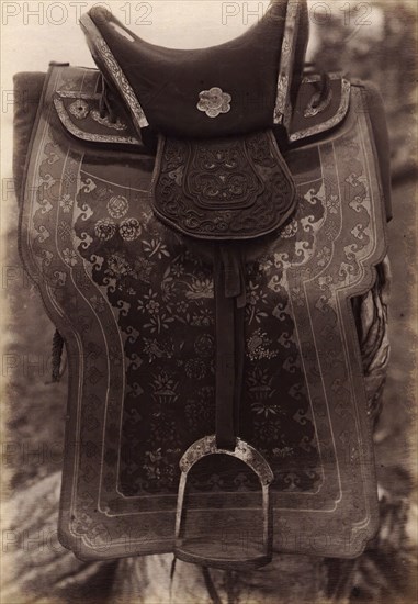Saddle with Chinese Saddle-Cloth and Silver Mongolia Engraving over Iron, 1897. Creator: Unknown.