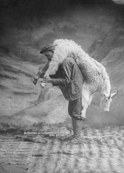 S.A. Crawford carrying a goat, 1905. Creator: Case & Draper.