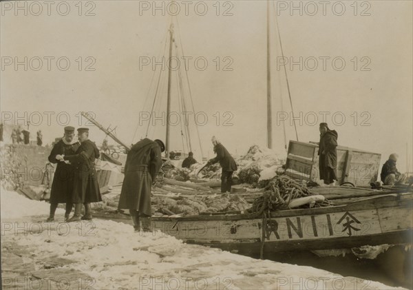 Japanese officers directing the unloading of supplies, Chemulpo, c1904. Creator: Robert Lee Dunn.