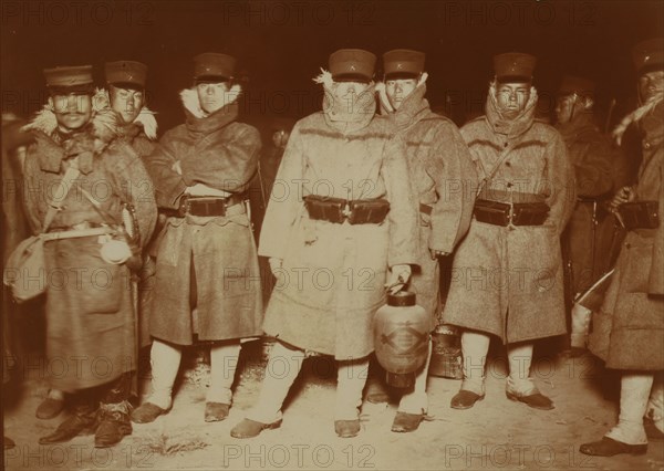 Japanese soldiers landed at Chemulpo after naval battle, waiting on a beach to entrain..., c1904. Creator: Robert Lee Dunn.