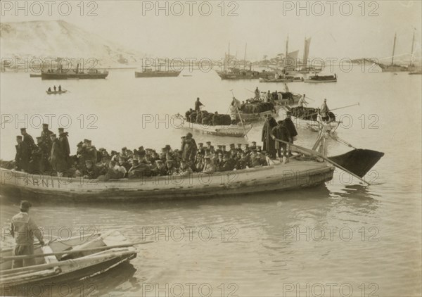 String of pontoons in tow of stream launch, approaching landing stage, Chemulpo, c1904. Creator: Robert Lee Dunn.