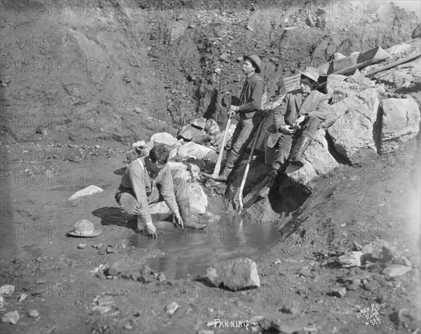 Men panning gold, between c1900 and 1927. Creator: Lomen Brothers.