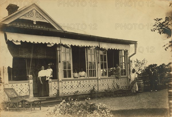 Dacha Seyuza, with the Pray family and servants posed on the front porch..., between 1907 and 1909. Creator: Eleanor Lord Pray.