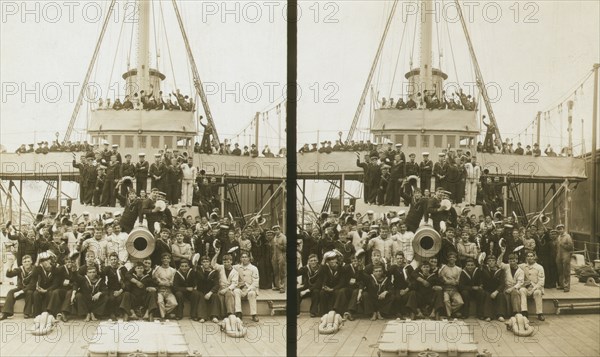 Sailors, probably American, and some civilians posed on a cruiser berthed in New York(?), c1905. Creator: Underwood & Underwood.