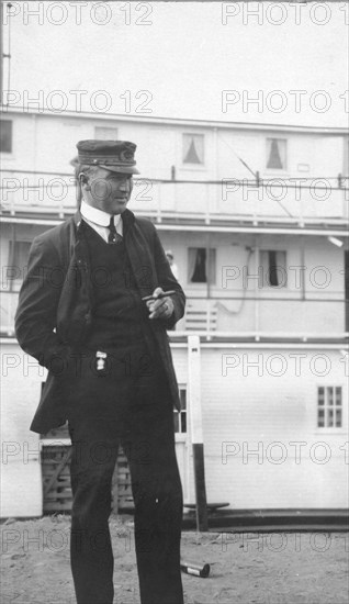 Uniformed man smoking a cigar, between c1900 and 1916. Creator: Unknown.