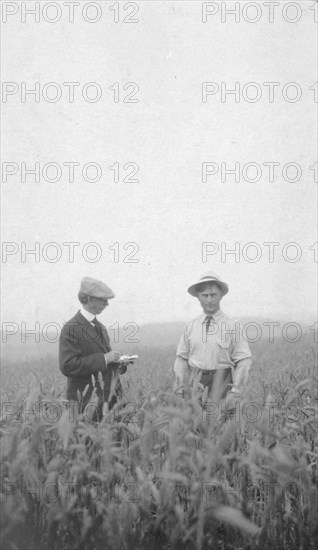 Frank G. Carpenter at an experimental farm, between c1900 and 1916. Creator: Unknown.