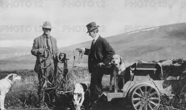 Frank G. Carpenter beside pupmobile, between c1900 and 1916. Creator: Unknown.