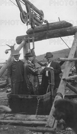 Frank G. Carpenter in middle of bucket at gold mine, between c1900 and 1916. Creator: Unknown.