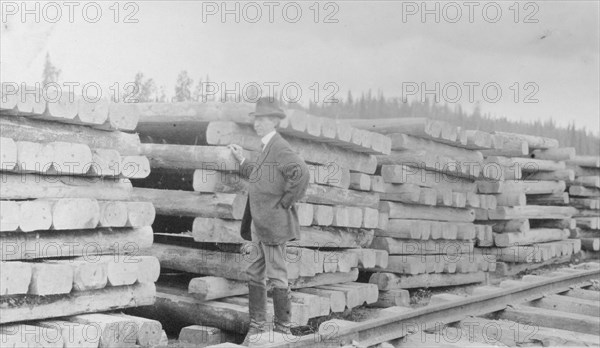 Frank G. Carpenter standing by railroad ties, between c1900 and 1916. Creator: Unknown.