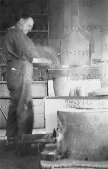 Mr. Kah smelting gold at the Assay Office, between c1900 and 1916. Creator: Unknown.