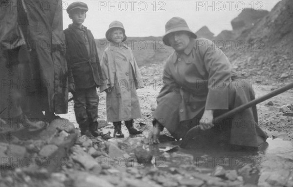 Mr. Lindeberg panning gold at Pioneer Mine with a shovel, between c1900 and 1916. Creator: Unknown.