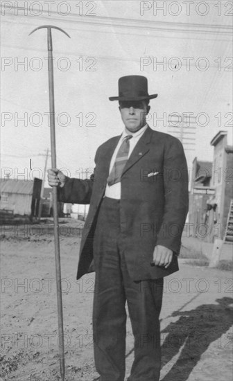 Man holding a tool, between c1900 and 1916. Creator: Unknown.