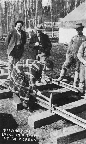 Babe White driving first spike in U.S. Railroad, between c1900 and c1930. Creator: Unknown.