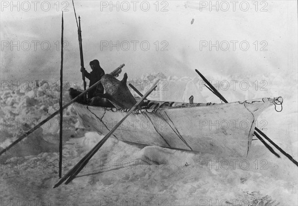 Eskimo in boat made with skins called an umiak, between c1900 and c1930. Creator: Unknown.