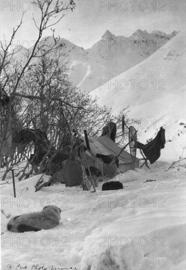 Explorer's tent and belongings anchored securely so they won't be blown away, c1900-c1930. Creator: Unknown.