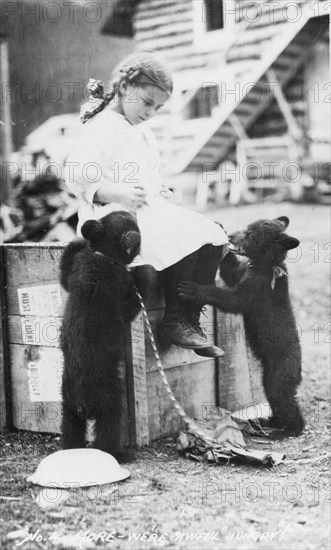 Girl with bear cubs, between c1900 and c1930. Creator: Unknown.