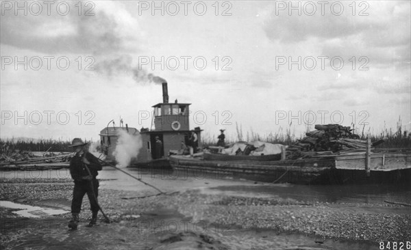 Steamer Little Delta and barge on sand bar, between c1900 and c1930. Creator: Unknown.