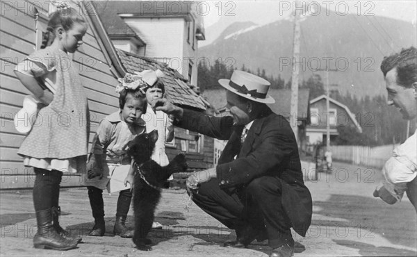 White people with bear cub, between c1900 and c1930. Creator: Unknown.