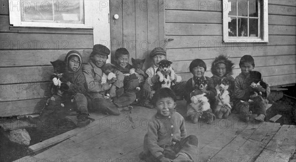 Eskimo children and puppies at the Moravian Mission Station, between c1900 and c1930. Creator: Unknown.