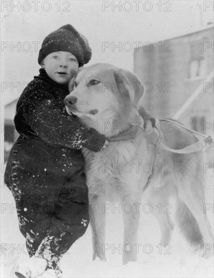 Child with dog, between c1900 and c1930. Creator: Unknown.