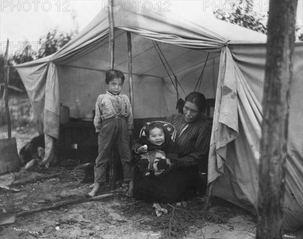 Indian children and mother at entrance of tent, between c1900 and 1927. Creator: Unknown.