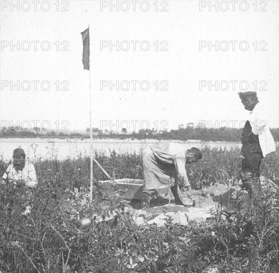 The moment of laying the benchmark on the river bank, 1909. Creator: Vladimir Ivanovich Fedorov.