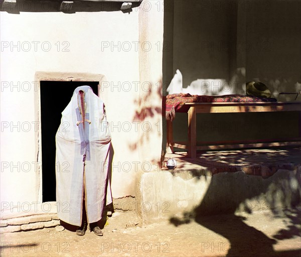 Woman in purdah, standing in front of doowrway, between 1905 and 1915. Creator: Sergey Mikhaylovich Prokudin-Gorsky.