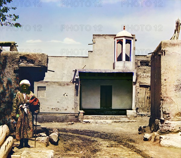 Man in courtyard, between 1905 and 1915. Creator: Sergey Mikhaylovich Prokudin-Gorsky.