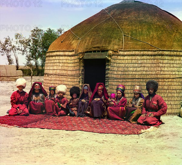 Group of eleven adults and children, seated on a rug, in front of a yurt, between 1905 and 1915. Creator: Sergey Mikhaylovich Prokudin-Gorsky.