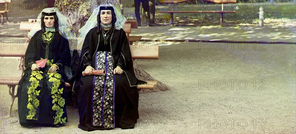 Georgian women in holiday attire in the park of Borzhom, between 1905 and 1915. Creator: Sergey Mikhaylovich Prokudin-Gorsky.