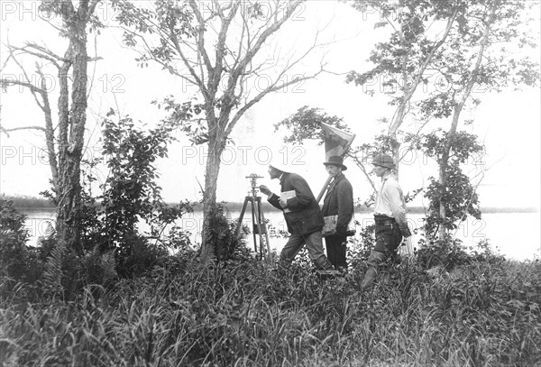 Prospectors conducting a triangulation survey from the bank of the Zeya River, 1909. Creator: Unknown.