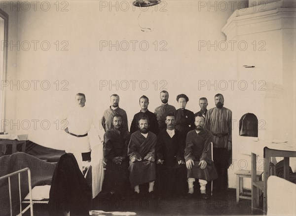 A group of people being treated in a hospital room, 1900. Creators: I. A. Podgorbunskii, V. I. Podgorbunskii.