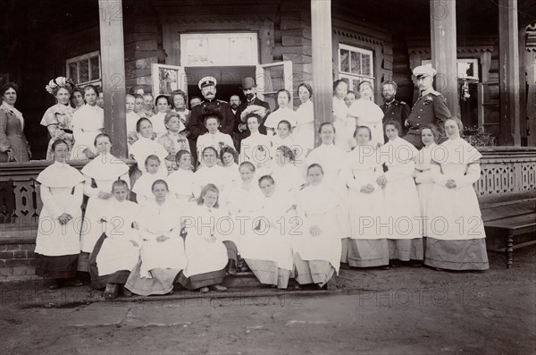 A group of students from the Maiden Institute with teachers on the porch of the dacha, 1900. Creators: I. A. Podgorbunskii, V. I. Podgorbunskii.