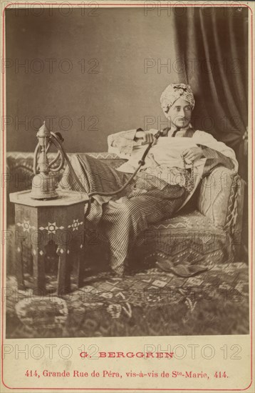Marquis Claes Lagergren (1853-1930) in eastern costume smoking a hookah. Creator: Guillaume Berggren.