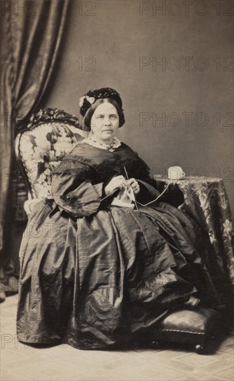 Business card, studio portrait of elderly woman knitting. (c1880s). Creator: Karolina Christianson.