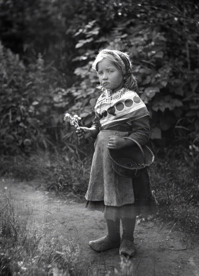 Little girl with basket and flowers in hands, 1898-1900.  Creator: Johan Severin Nilson.