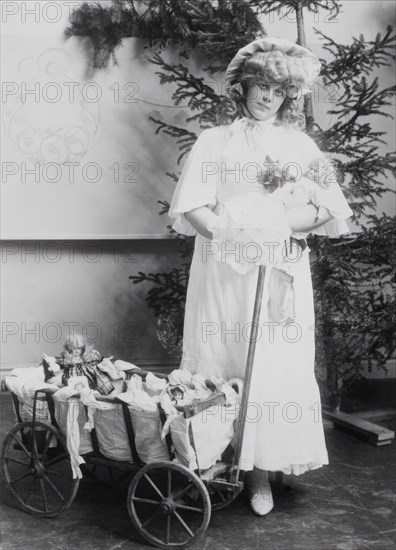 Girl with dolls and doll carriage, 1900.  Creator: Unknown.