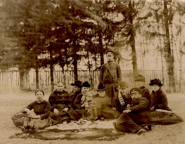 G.V. Iudina's Family with Their Guests in the Garden at the Dacha in Tarakanovo, 1907. Creator: Unknown.